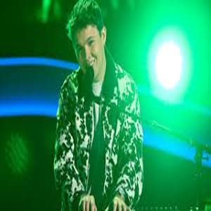 Max Cooper III performing on The Voice Season 28 stage during his blind audition