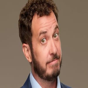 Rick Devens in his official Big Brother Season 28 cast portrait wearing a blue suit and smiling.